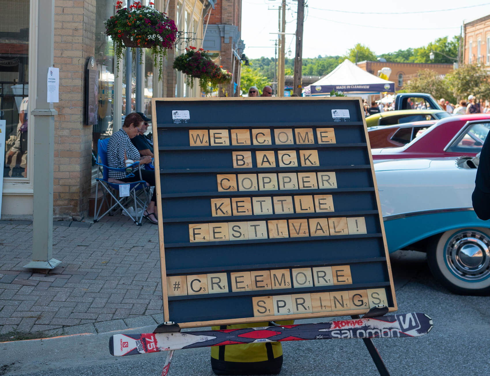 pieces scrabble sign forming the word "welcome copper kettle festival #Creemore springs