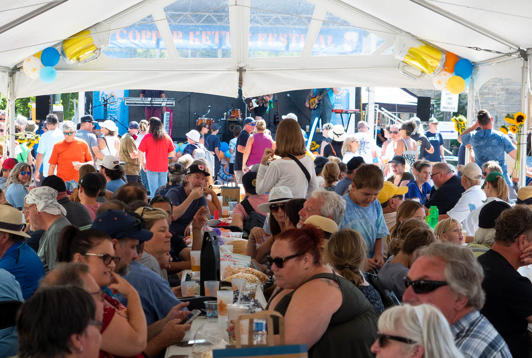 people sitting together at a table at copper kettler festival