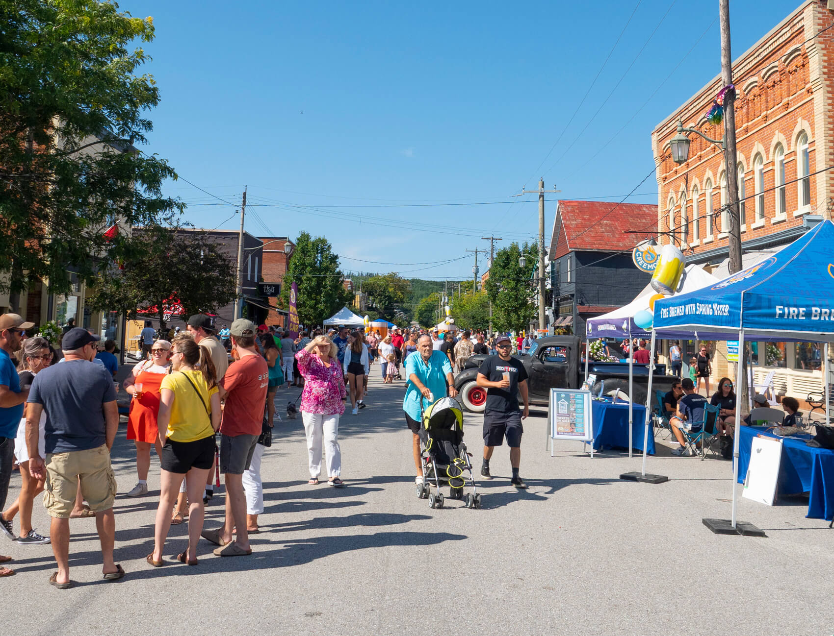 people walking among the stalls at the copper kettle festival