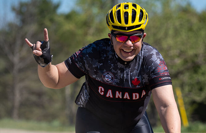 man smiling while riding a bicycle