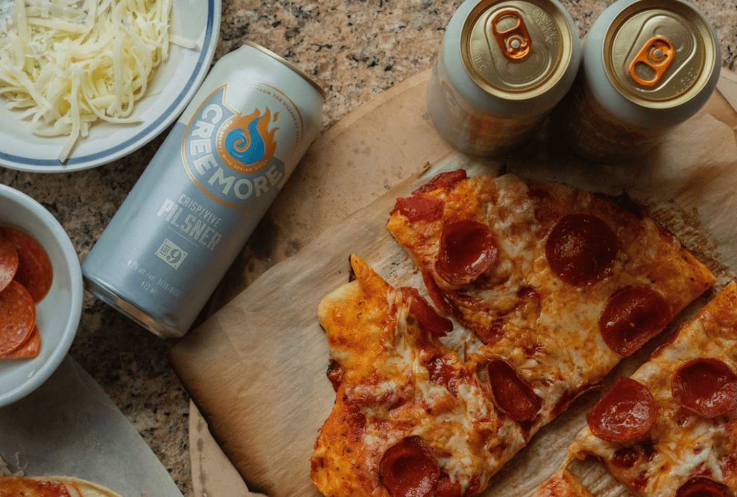 creemore beer can next to slices of pizza