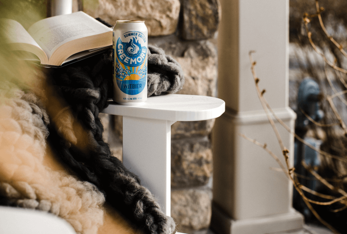 witbier can in a table with book