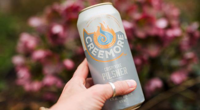 creemore pilsner can in a hand with background faded